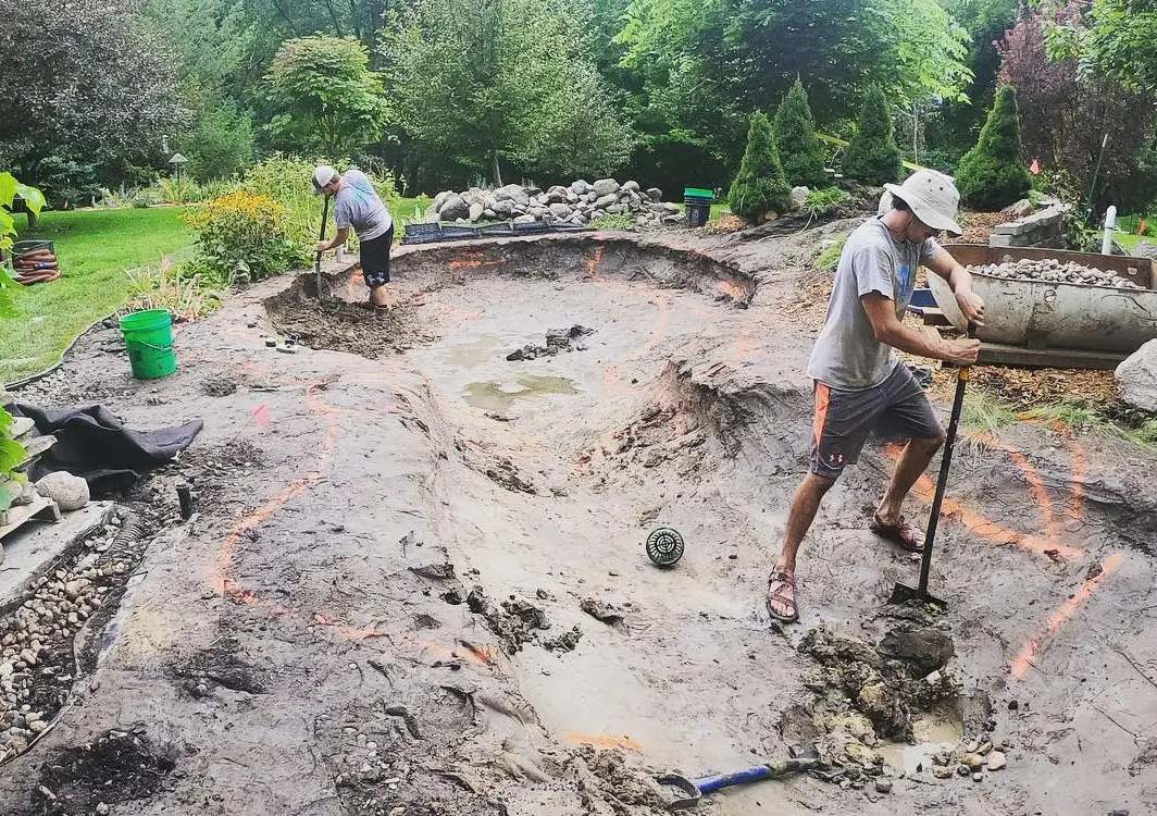 Just Add Water crew digging and shaping a new pond excavation