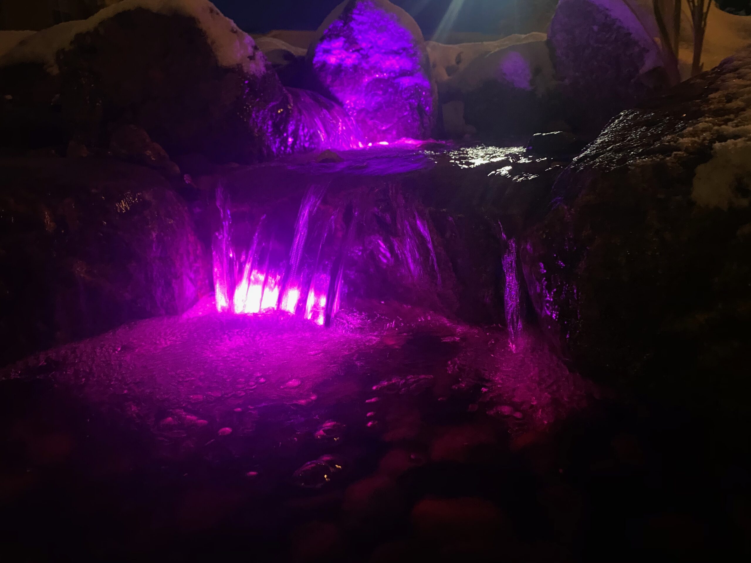 Evening view of a lit water feature