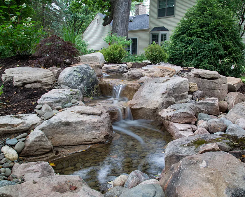 Backyard pondless waterfall built by Just Add Water in Central Iowa