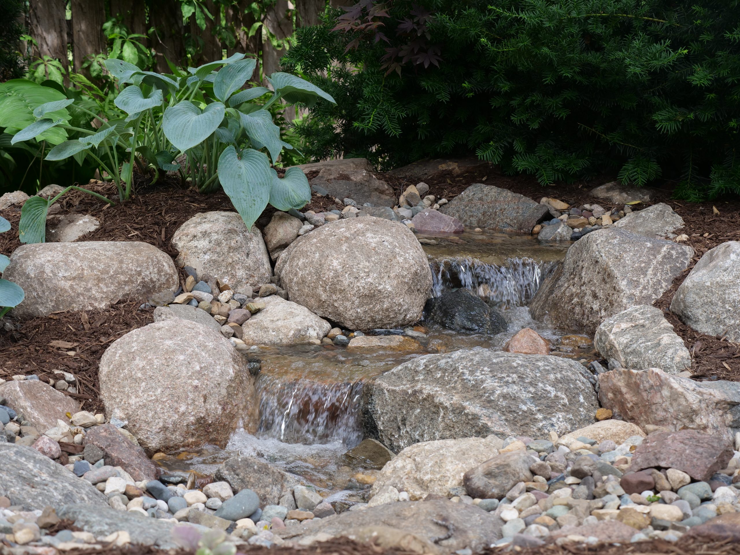 Stone and planting details around the waterfall