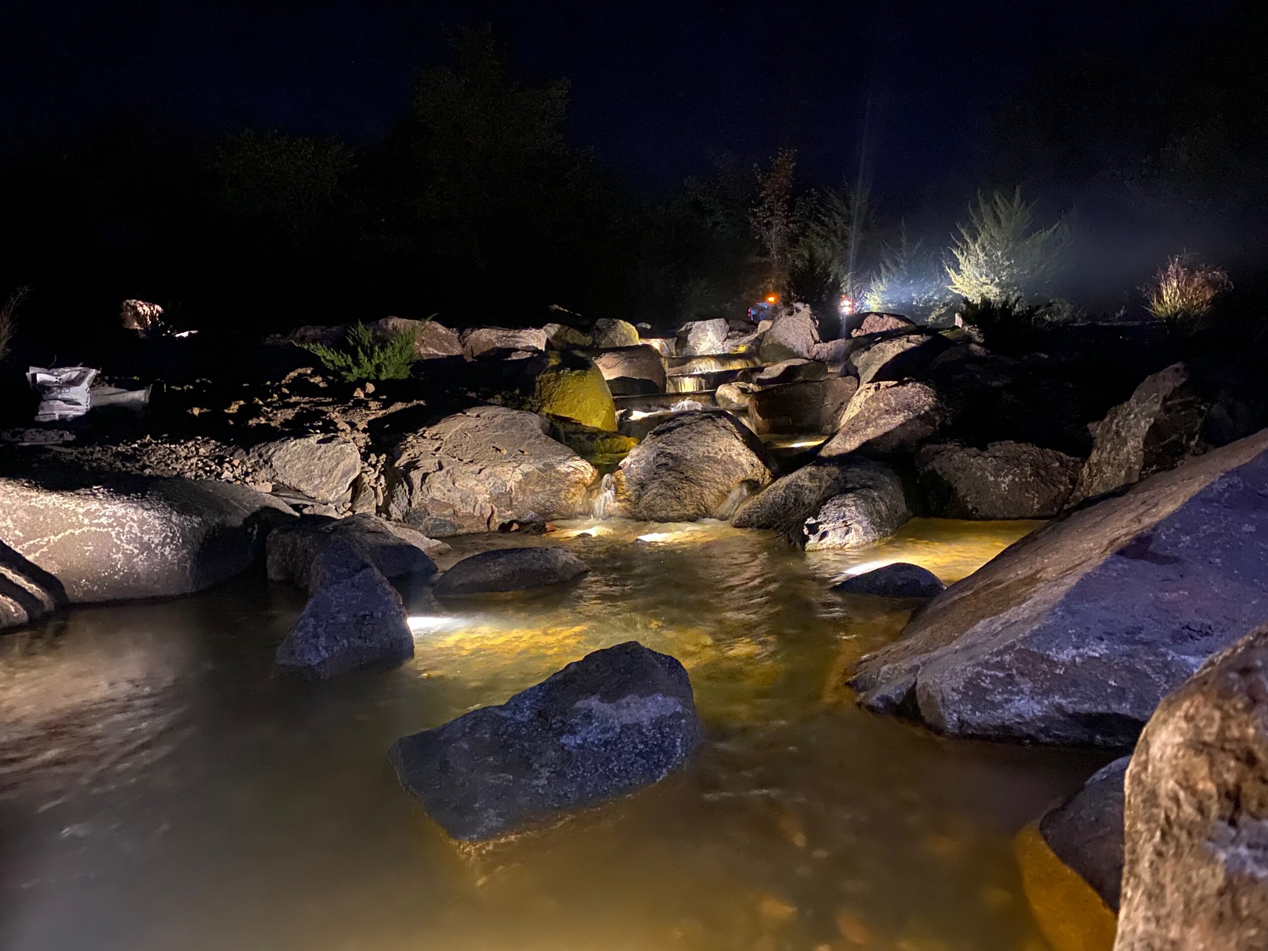 Landscape pond lighting along a stream