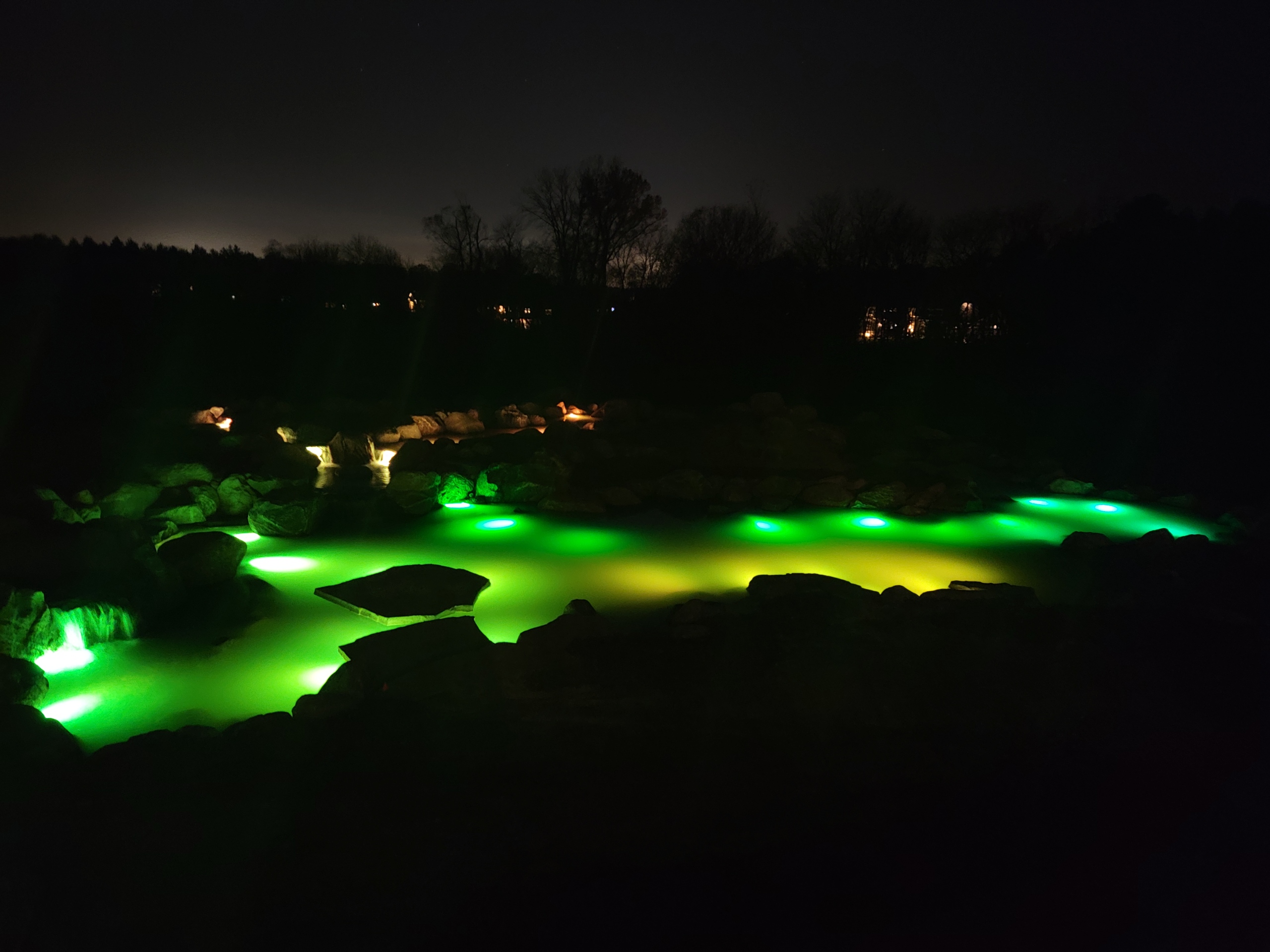 Underwater LED lighting illuminating a pond at night